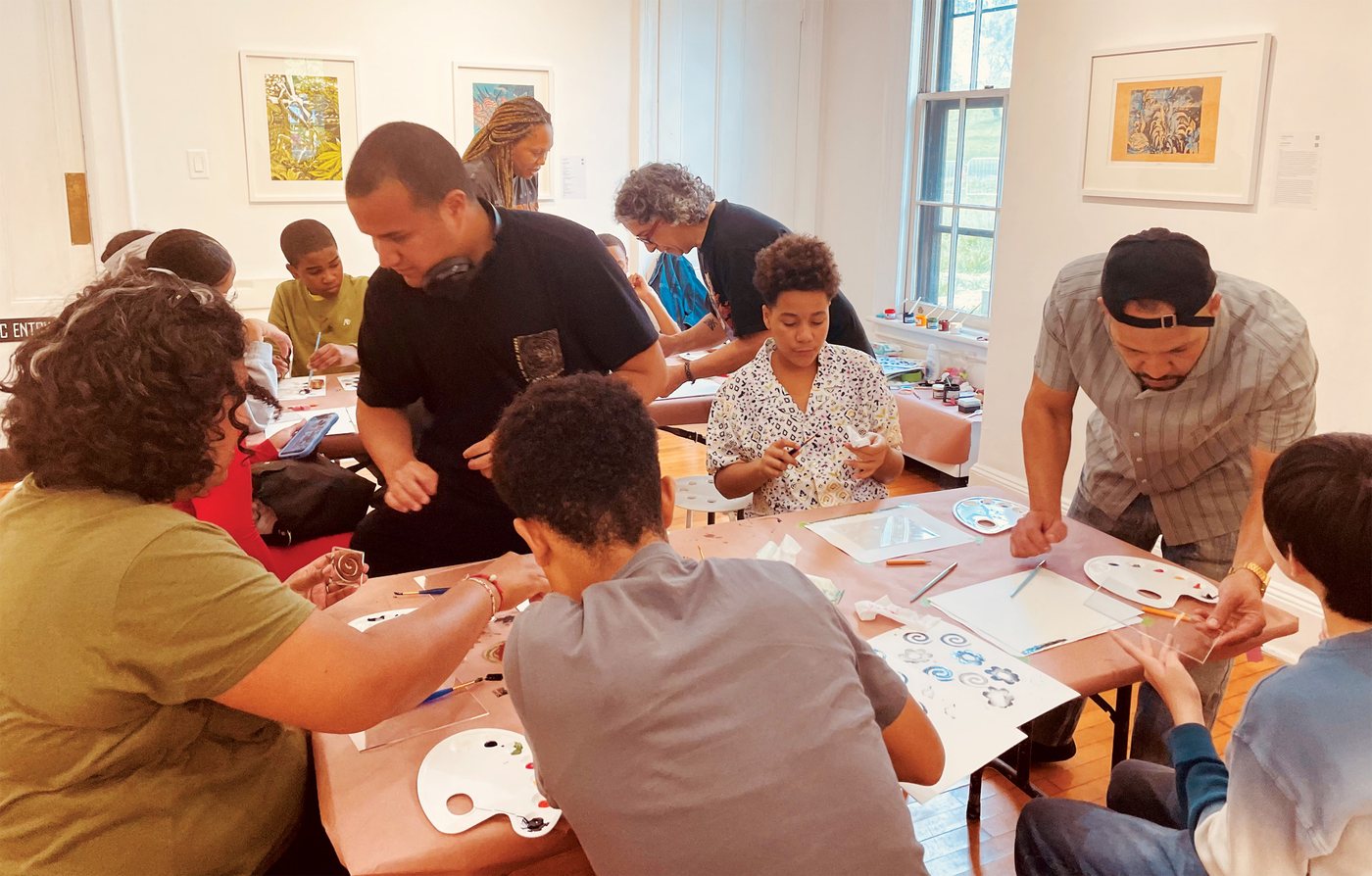 Children and parents printing together at the Print 4 Fun art workshop